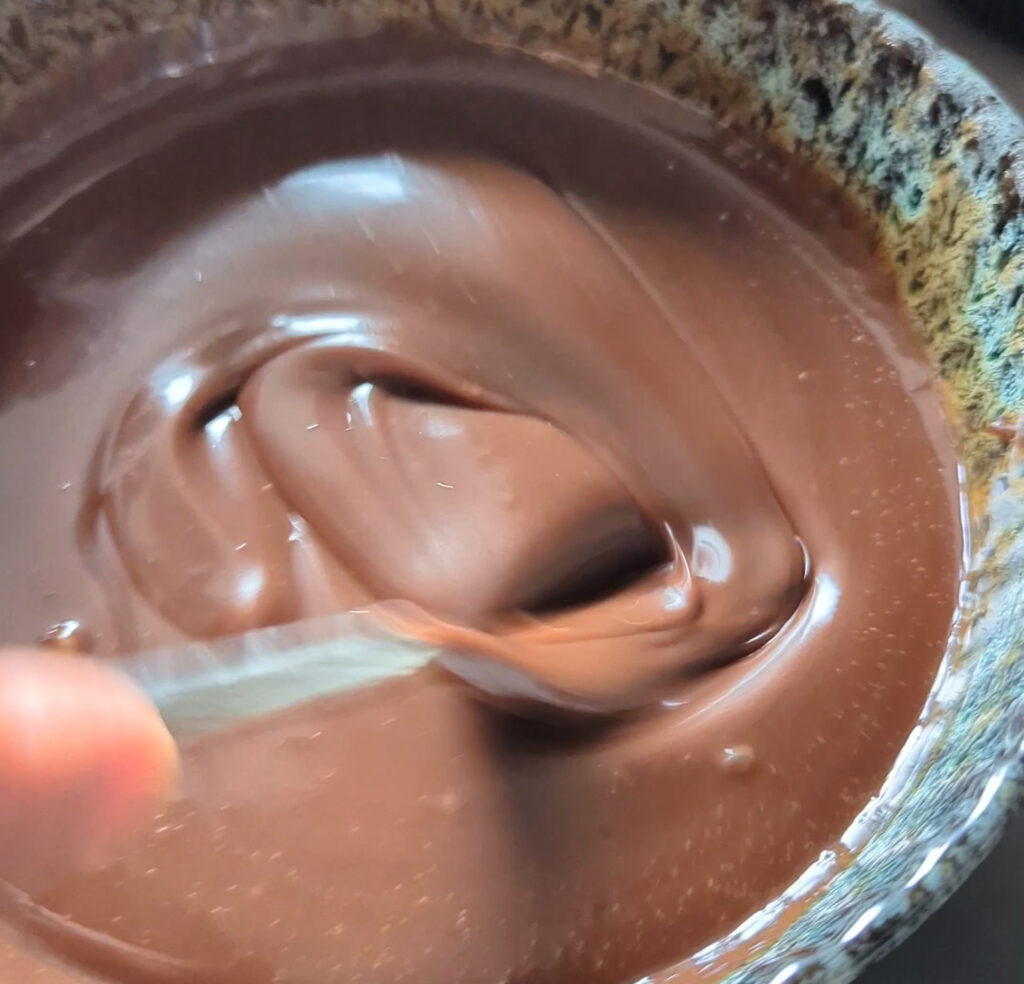 chocolate ganache being stirred